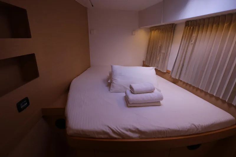 Petalida Yacht Photos Pics Cozy bedroom in 2017 Lagoon 42 catamaran with neatly arranged bed linens.