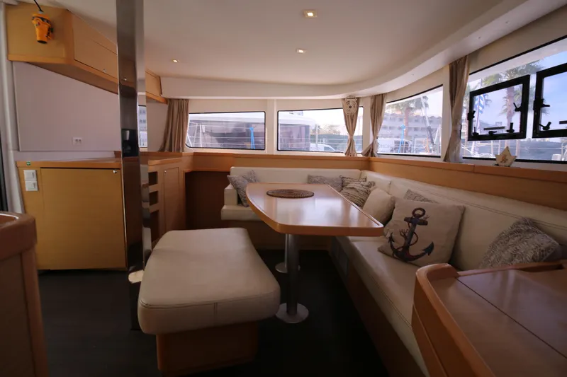 Petalida Yacht Photos Pics Interior of 2017 Lagoon 42 catamaran with cozy seating and dining area.