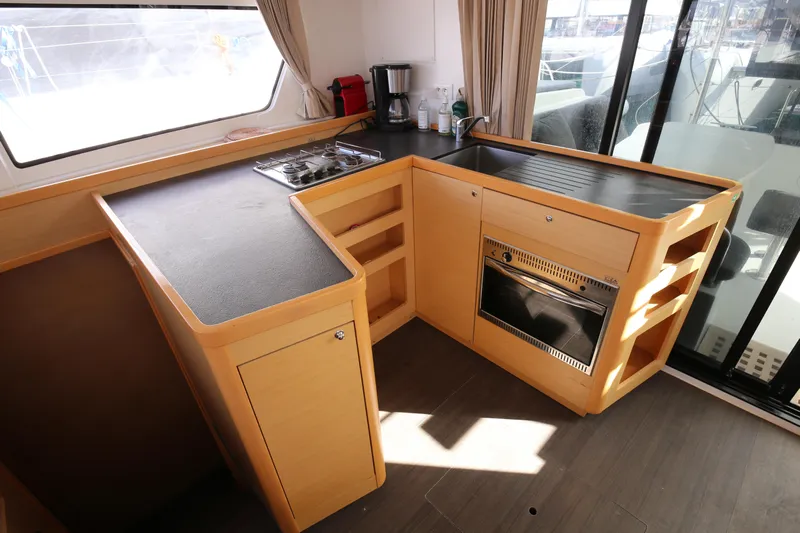 Petalida Yacht Photos Pics Modern kitchen interior of 2017 Lagoon 42 catamaran with stove and oven.