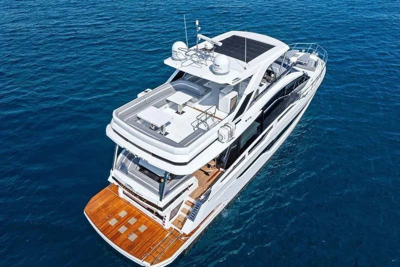 Triple T Yacht Photos Pics 2022 Galeon 640 Fly yacht on open sea, showcasing luxurious design and spacious deck.