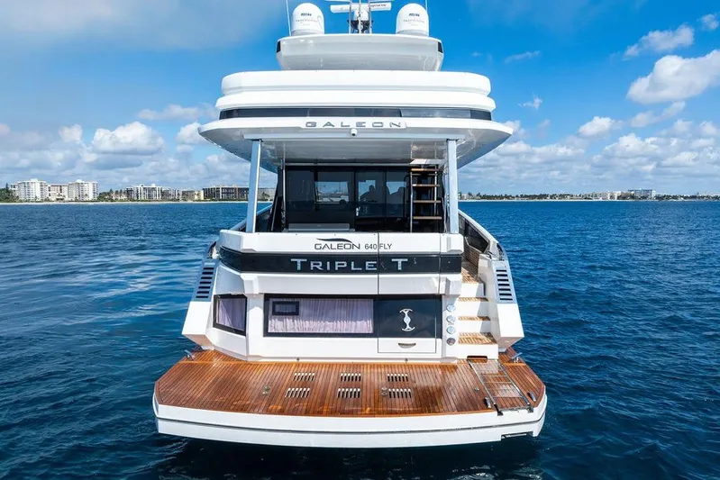 Triple T Yacht Photos Pics 2022 Galeon 640 Fly yacht on open water, rear view with clear sky.