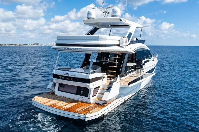 Triple T Yacht Photos Pics Luxurious 2022 Galeon 640 Fly yacht cruising on open sea under blue skies.