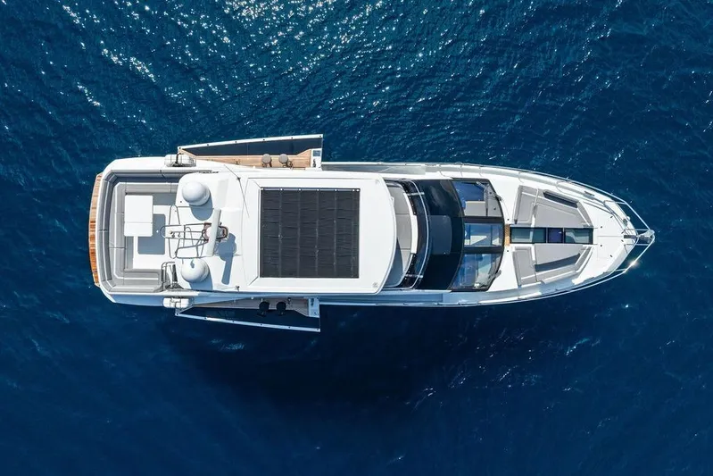 Triple T Yacht Photos Pics Aerial view of 2022 Galeon 640 Fly yacht on blue ocean water.