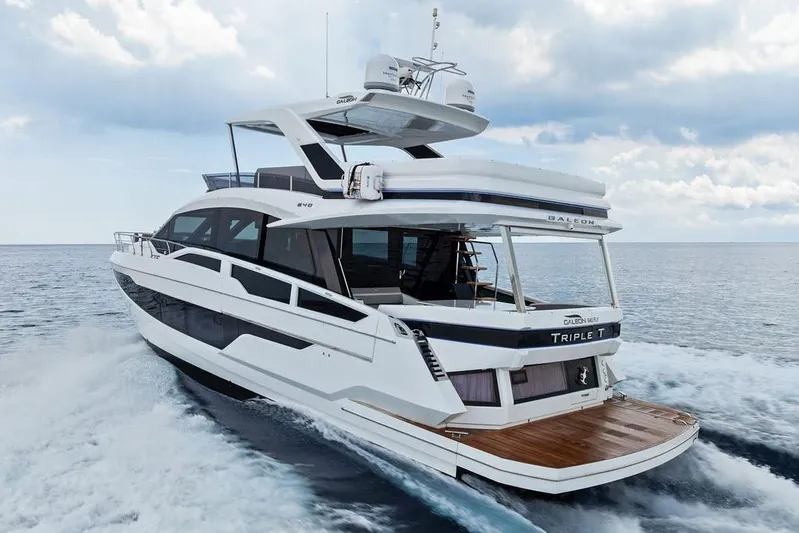 Triple T Yacht Photos Pics 2022 Galeon 640 Fly yacht cruising on open water under a cloudy sky.