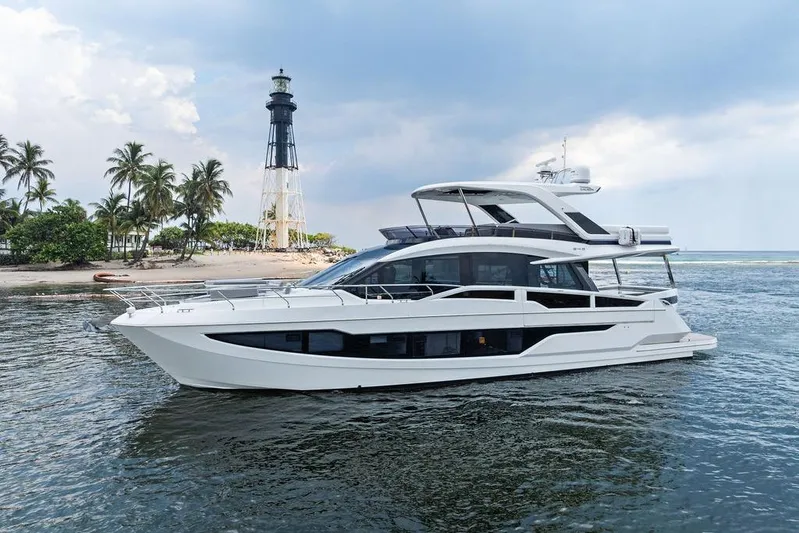 Triple T Yacht Photos Pics 2022 Galeon 640 Fly yacht near a lighthouse and palm trees.