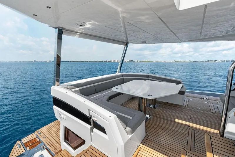 Triple T Yacht Photos Pics Luxurious 2022 Galeon 640 Fly yacht deck with seating, overlooking serene ocean view.