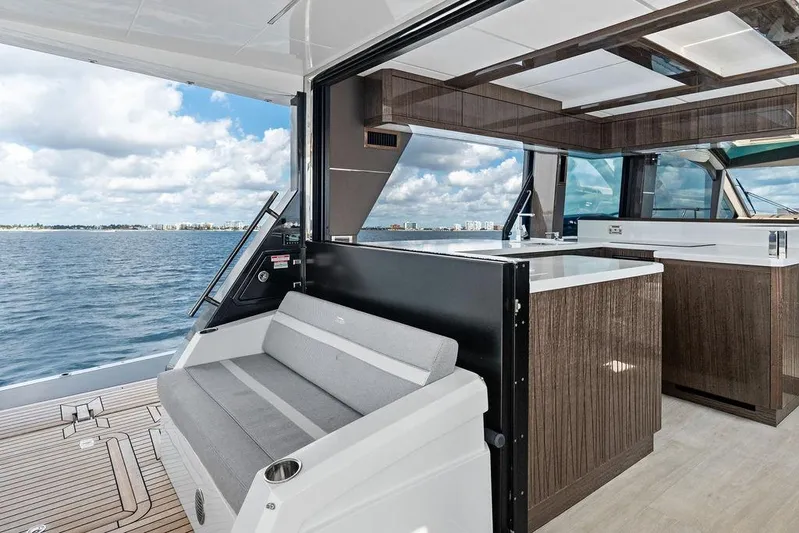 Triple T Yacht Photos Pics Luxurious 2022 Galeon 640 Fly yacht interior with modern seating and ocean view.
