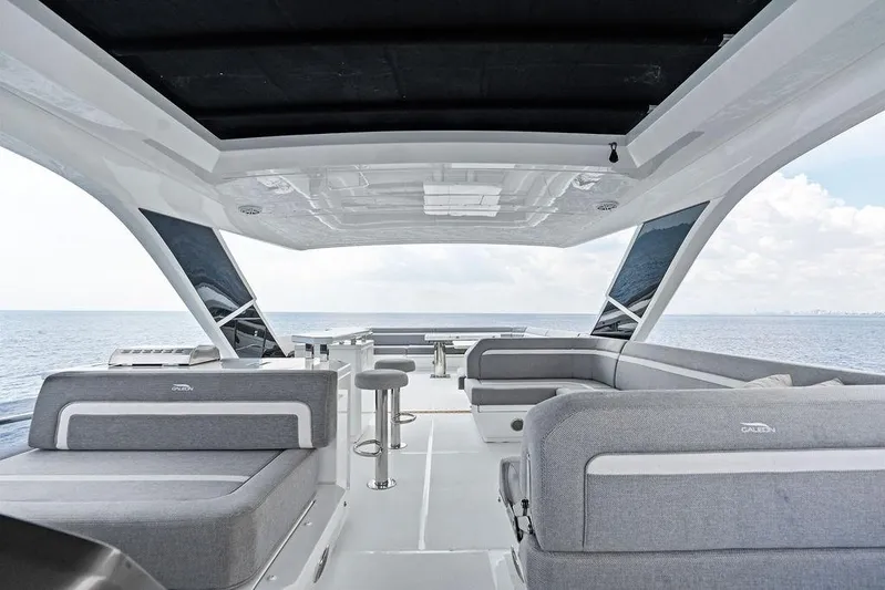 Triple T Yacht Photos Pics Luxurious 2022 Galeon 640 Fly yacht interior with modern seating and ocean view.