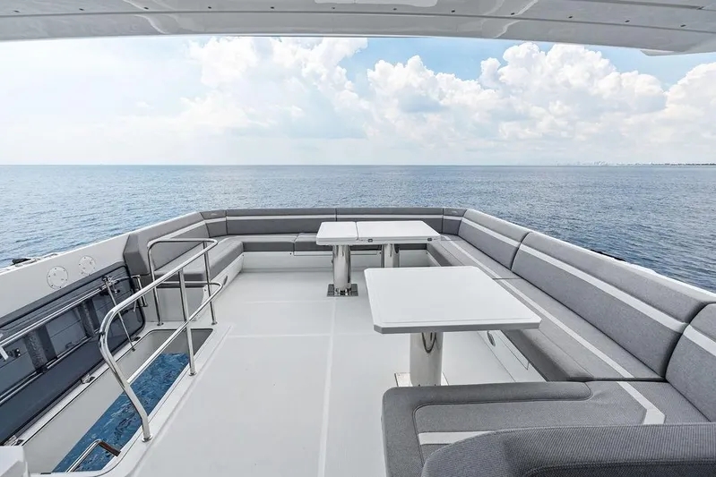 Triple T Yacht Photos Pics Luxurious 2022 Galeon 640 Fly yacht deck with seating, overlooking serene ocean view.