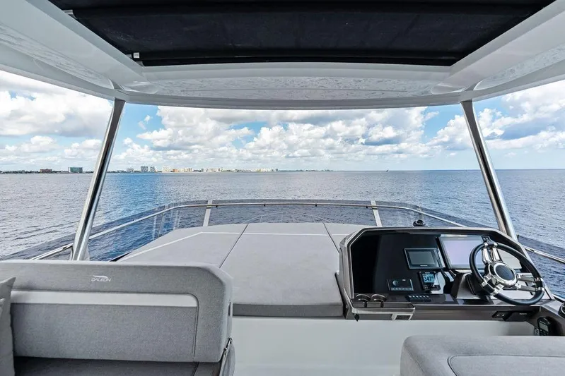 Triple T Yacht Photos Pics Flybridge view from 2022 Galeon 640 Fly yacht, overlooking the ocean and distant skyline.