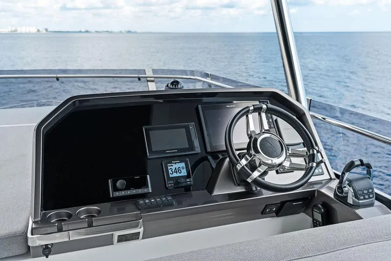 Triple T Yacht Photos Pics Helm of 2022 Galeon 640 Fly yacht with modern navigation equipment and ocean view.