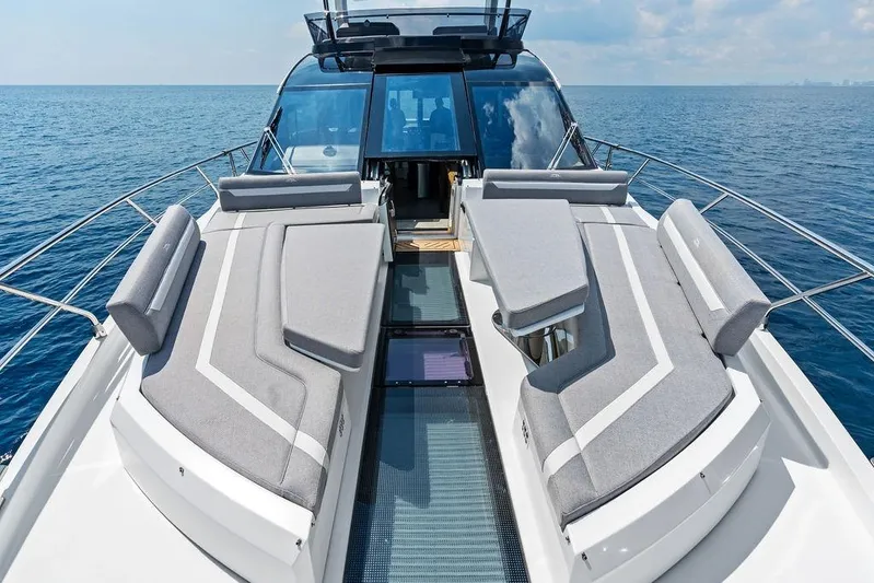 Triple T Yacht Photos Pics Luxurious 2022 Galeon 640 Fly yacht with spacious deck and modern seating on open sea.