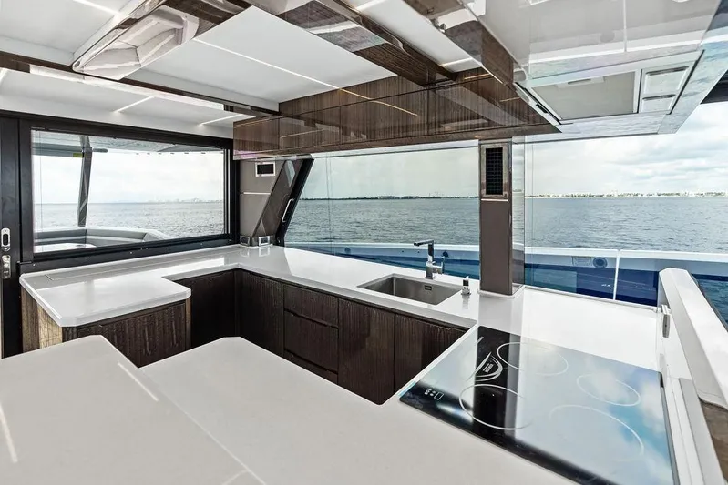 Triple T Yacht Photos Pics Luxurious kitchen interior of 2022 Galeon 640 Fly yacht with ocean view.