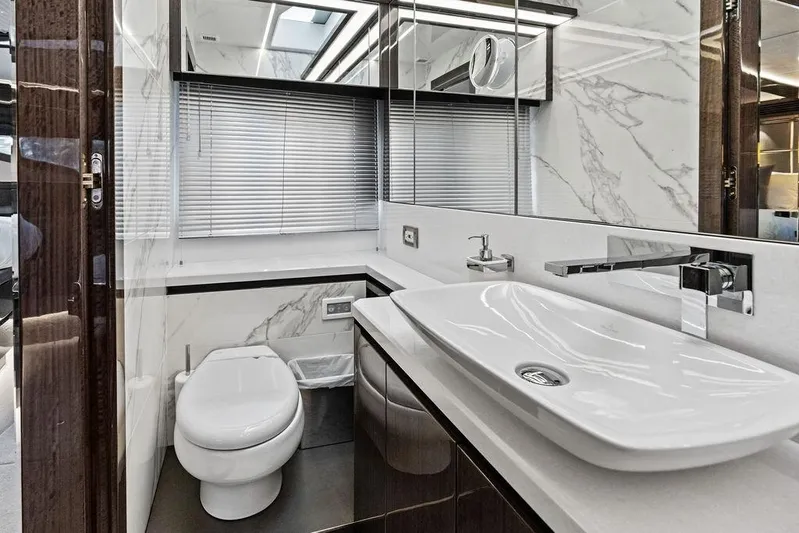 Triple T Yacht Photos Pics Luxurious bathroom in 2022 Galeon 640 Fly yacht with modern fixtures and marble accents.