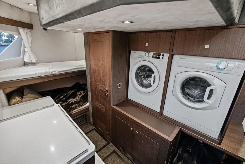 Triple T Yacht Photos Pics Laundry area with washer and dryer in 2022 Galeon 640 Fly yacht interior.