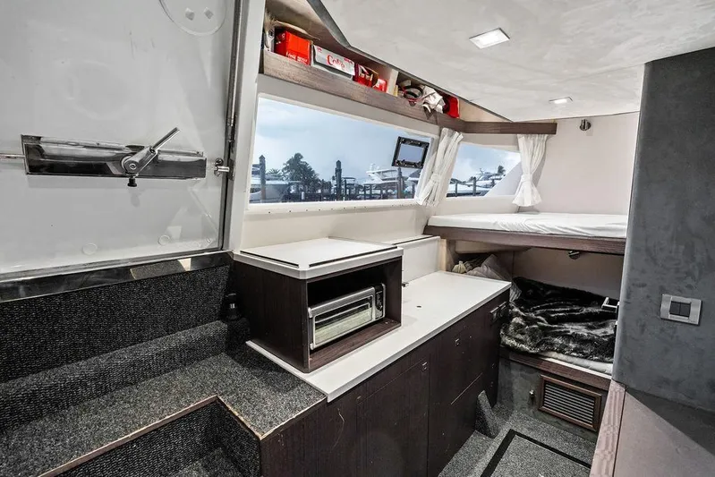 Triple T Yacht Photos Pics Luxurious interior of 2022 Galeon 640 Fly yacht with modern amenities and cozy sleeping area.