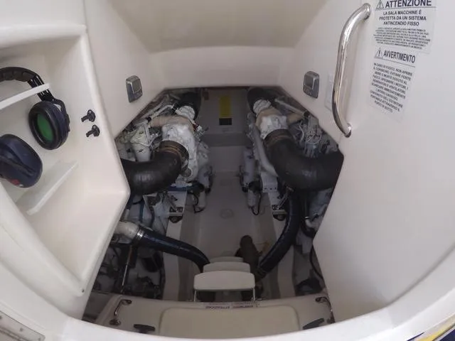 Cabo 43fb Yacht Photos Pics Engine room of a 2007 Cabo 43 FB boat, featuring dual engines and safety instructions.