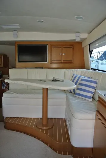 Cabo 43fb Yacht Photos Pics Interior of 2007 Cabo 43 FB yacht with white seating and striped cushions.