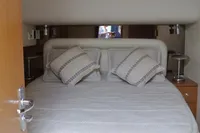 2007 Cabo 43 FB yacht cabin with cozy bed and pillows.