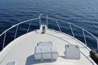2007 Cabo 43 FB yacht bow view on calm ocean waters.