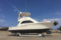2007 Cabo 43 FB yacht on trailer under clear blue sky.