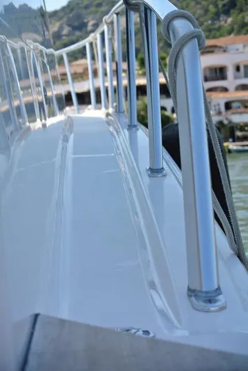 Cabo 43fb Yacht Photos Pics 2007 Cabo 43 FB yacht deck with railing, docked near waterfront buildings.