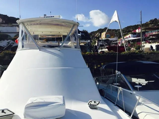 Cabo 43fb Yacht Photos Pics 2007 Cabo 43 FB yacht docked in a scenic marina setting.