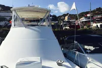 2007 Cabo 43 FB yacht docked in a scenic marina setting.