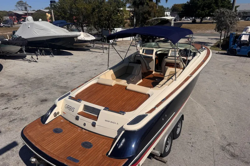  Yacht Photos Pics 2019 Chris-Craft Corsair 30 boat with wooden deck and canopy, parked on a trailer.