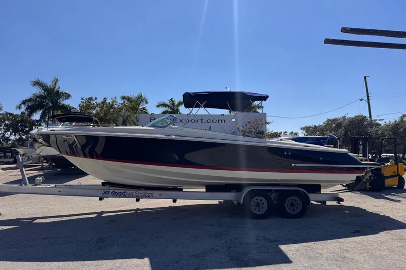  Yacht Photos Pics 2019 Chris-Craft Corsair 30 boat on trailer, parked outdoors under clear blue sky.