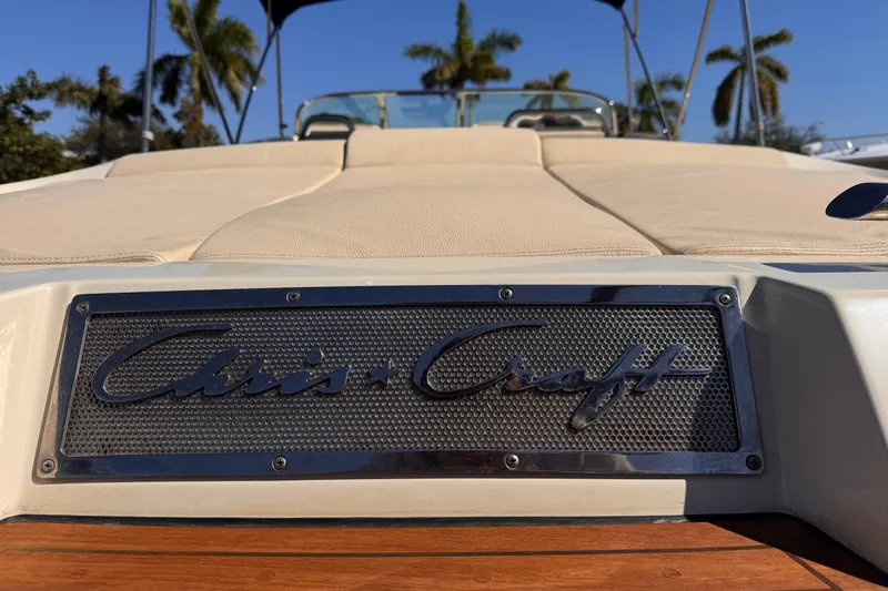  Yacht Photos Pics 2019 Chris-Craft Corsair 30 boat with logo, beige seating, and palm trees in background.