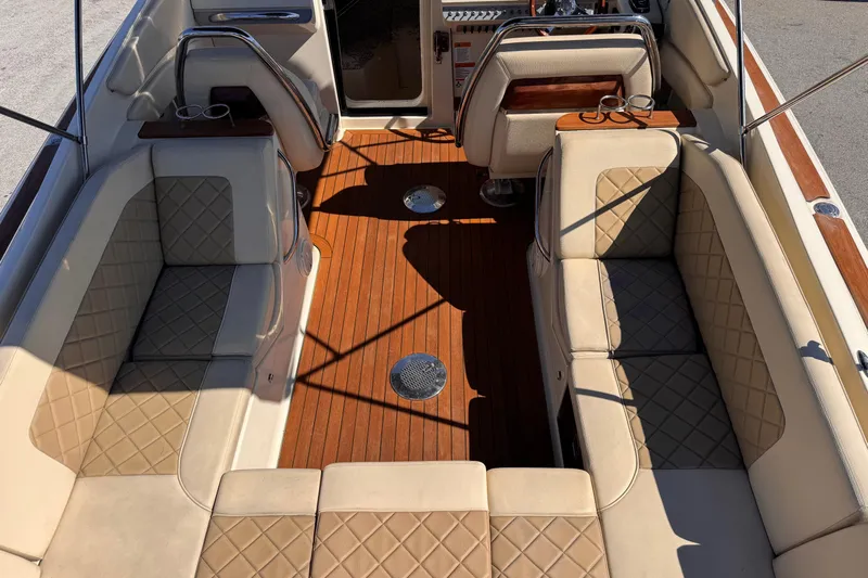  Yacht Photos Pics Luxurious interior of 2019 Chris-Craft Corsair 30 with elegant seating and wood flooring.