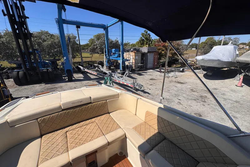  Yacht Photos Pics 2019 Chris-Craft Corsair 30 boat interior with tan quilted seating at a marina.