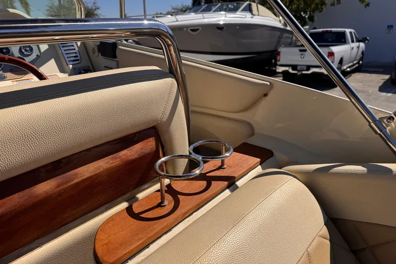  Yacht Photos Pics 2019 Chris-Craft Corsair 30 interior with beige leather seats and cup holders.
