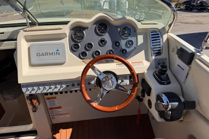  Yacht Photos Pics 2019 Chris-Craft Corsair 30 dashboard with Garmin navigation and wooden steering wheel.