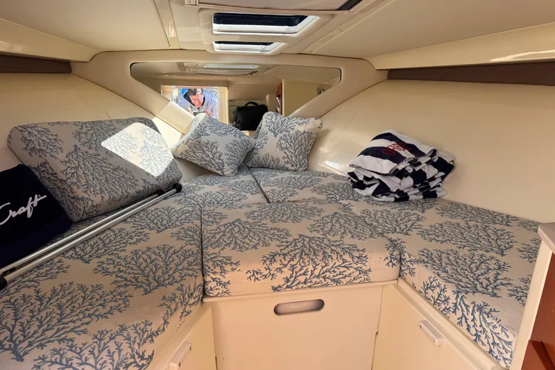  Yacht Photos Pics 2019 Chris-Craft Corsair 30 cabin interior with patterned cushions and skylight.