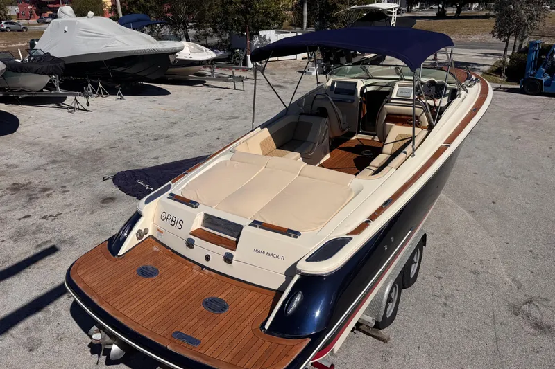  Yacht Photos Pics 2019 Chris-Craft Corsair 30 boat with teak deck and navy canopy, parked on trailer.