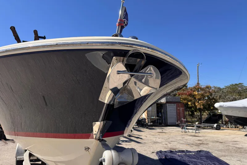  Yacht Photos Pics 2019 Chris-Craft Corsair 30 boat with anchor, parked outdoors under clear blue sky.