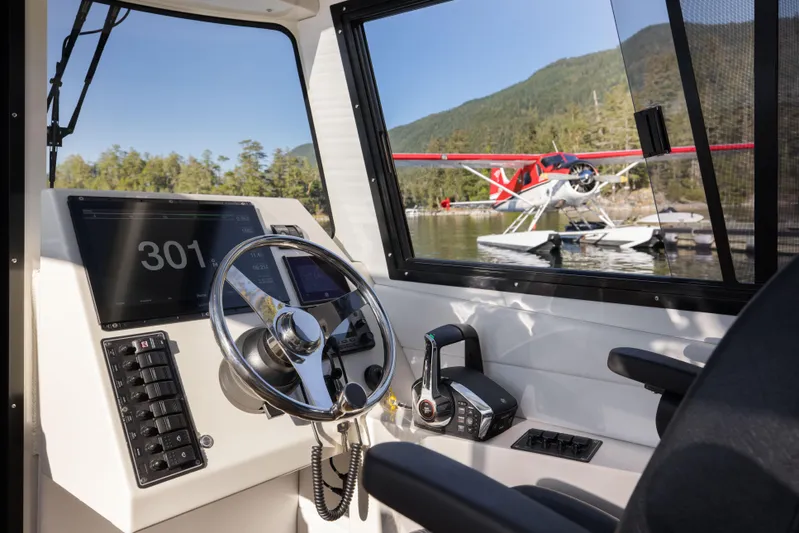Jasper Marine Defender 22 Yacht Photos Pics Interior of 2025 Jasper Marine Defender 22 boat with scenic view of seaplane and mountains.