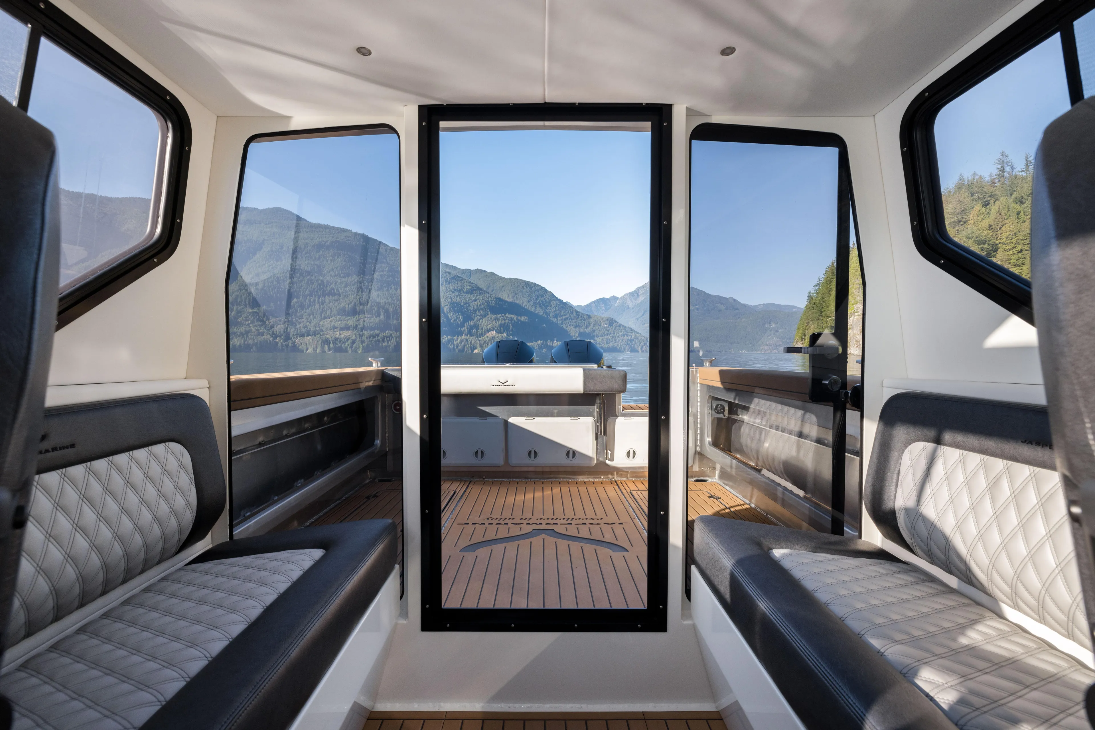 Jasper Marine Defender 22 Yacht Photos Pics Interior view of 2025 Jasper Marine Defender 22 - Storm Bow, showcasing seating and scenic mountain backdrop.