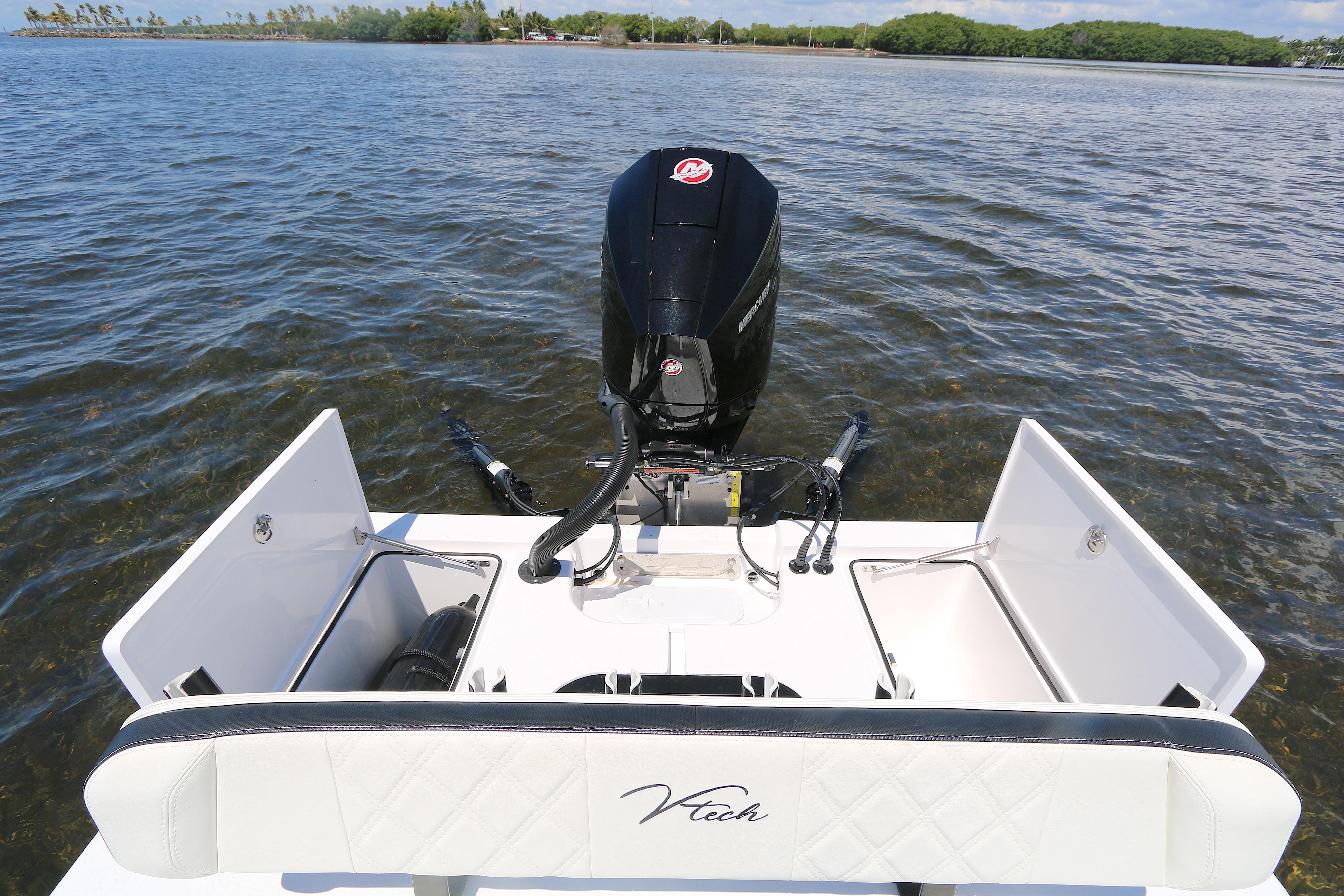 2024 Vtech 18 boat with outboard motor on calm water.