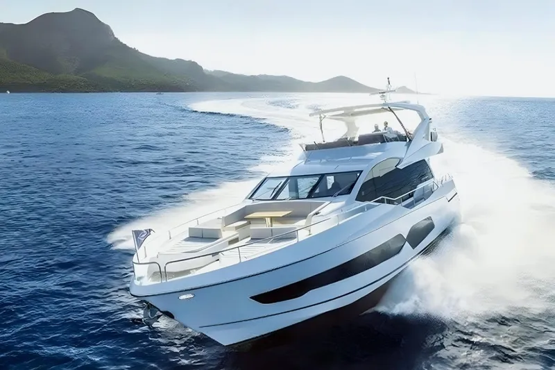 Sarahlisa Yacht Photos Pics Luxurious 2015 Sunseeker 75 yacht cruising on open sea near scenic coastline.