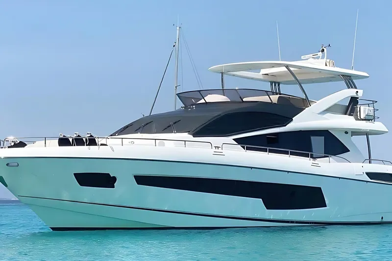 Sarahlisa Yacht Photos Pics Luxurious 2015 Sunseeker 75 yacht on clear blue water under a sunny sky.