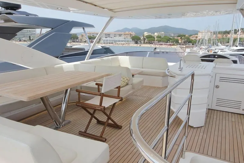 Sarahlisa Yacht Photos Pics Luxurious 2015 Sunseeker 75 yacht deck with seating and scenic marina view.