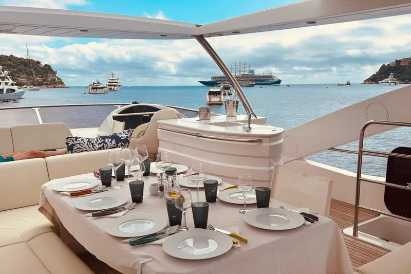 Sarahlisa Yacht Photos Pics Luxurious dining setup on a 2015 Sunseeker 75 yacht with ocean view.