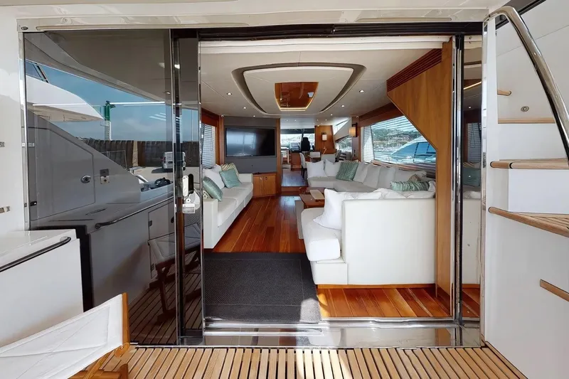 Sarahlisa Yacht Photos Pics Luxurious interior of 2015 Sunseeker 75 yacht with elegant white seating and wooden flooring.