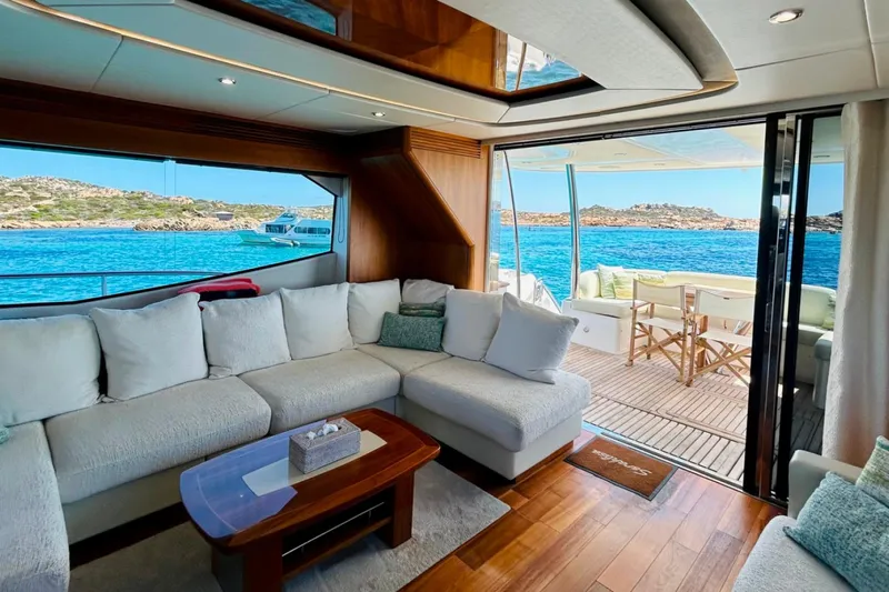 Sarahlisa Yacht Photos Pics Luxurious Sunseeker 75 yacht interior with ocean view, featuring elegant seating and wooden accents.