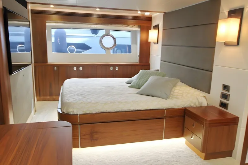 Sarahlisa Yacht Photos Pics Luxurious bedroom interior of 2015 Sunseeker 75 yacht with modern design and elegant furnishings.