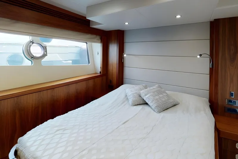Sarahlisa Yacht Photos Pics Luxurious bedroom interior of 2015 Sunseeker 75 yacht with modern design and cozy bedding.