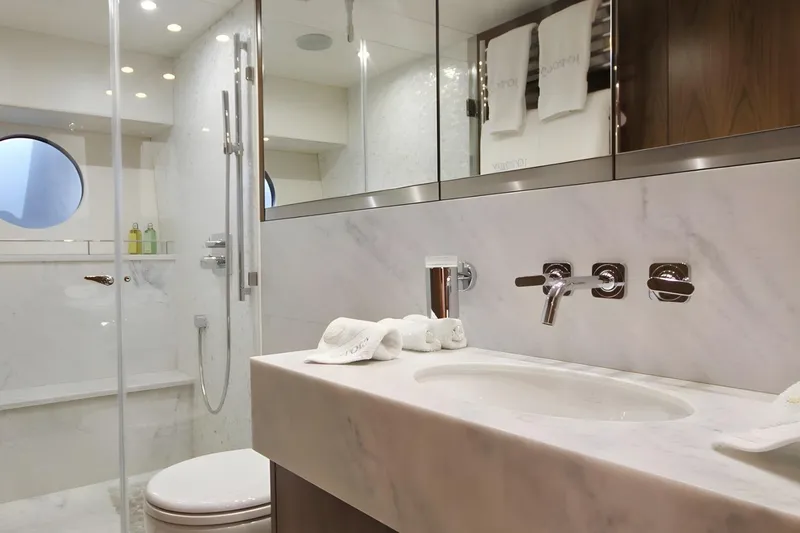 Sarahlisa Yacht Photos Pics Luxurious bathroom in a 2015 Sunseeker 75 yacht, featuring elegant marble and modern fixtures.